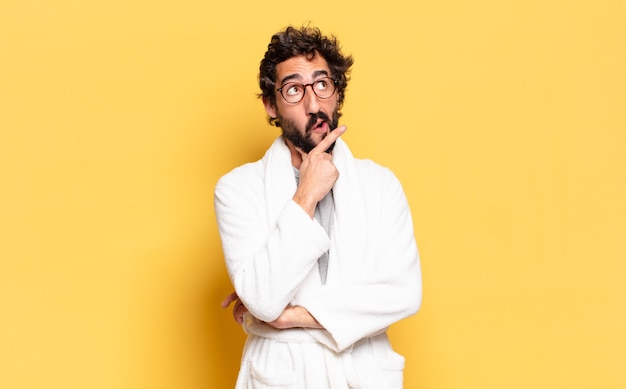 Young bearded man wearing bathrobe