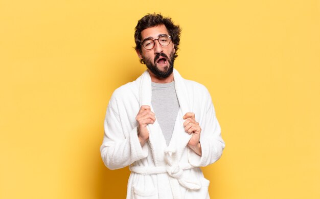 Young bearded man wearing bathrobe