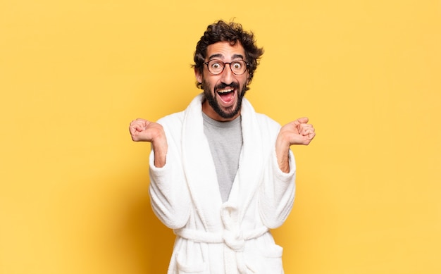 Young bearded man wearing bathrobe