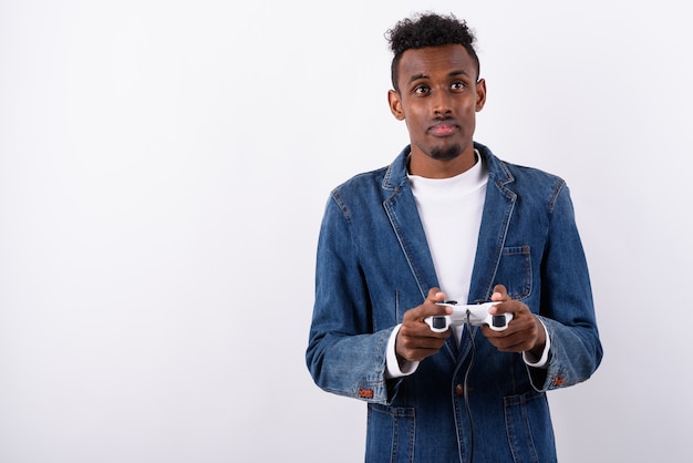 Young bearded man wearing denim jacket against white