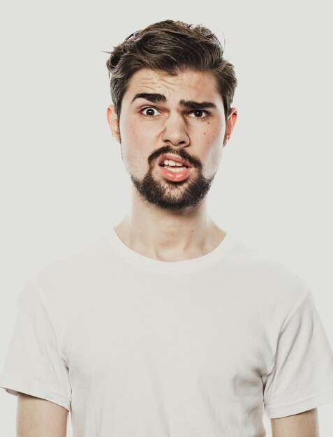 Young bearded man over white background