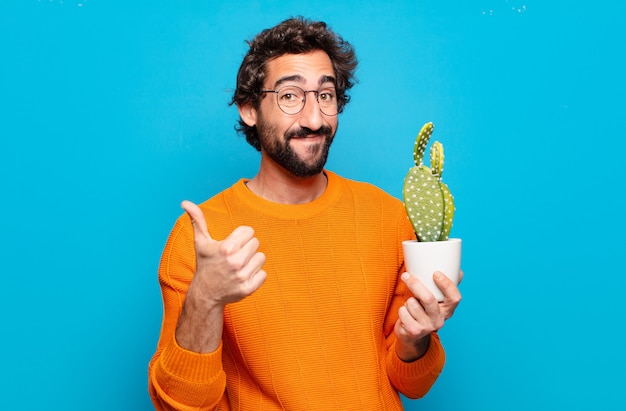 Young bearded man with a cactus plant