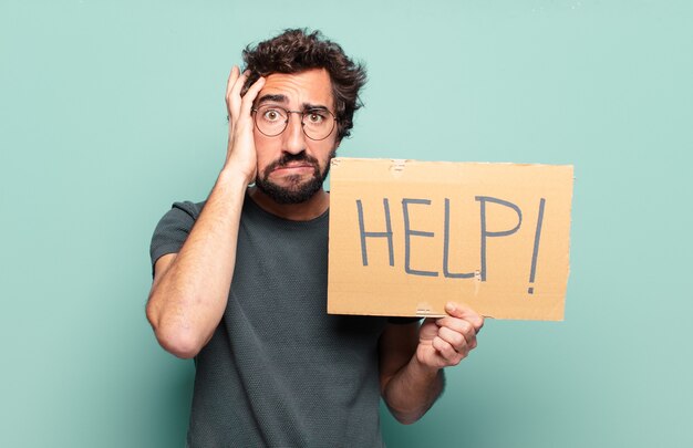 Young bearded man with help banner