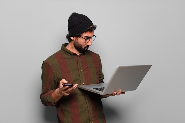 Young bearded man with a laptop