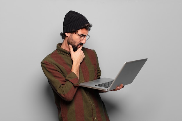 Young bearded man with a laptop