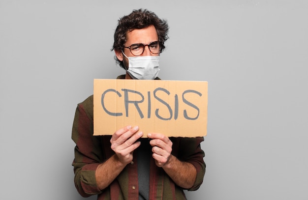 Young bearded man with a medical mask. crisis concpet