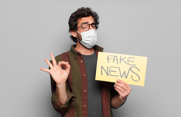 Young bearded man with a medical mask and fake news concept