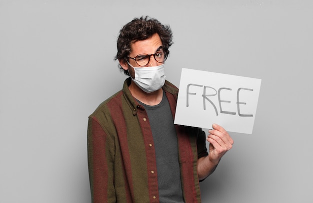 Young bearded man with a medical mask and free banner concept