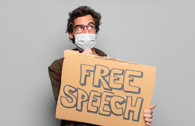 Young bearded man with a medical mask and free speech concept