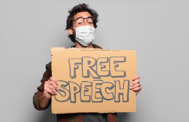 Young bearded man with a medical mask and free speech concept