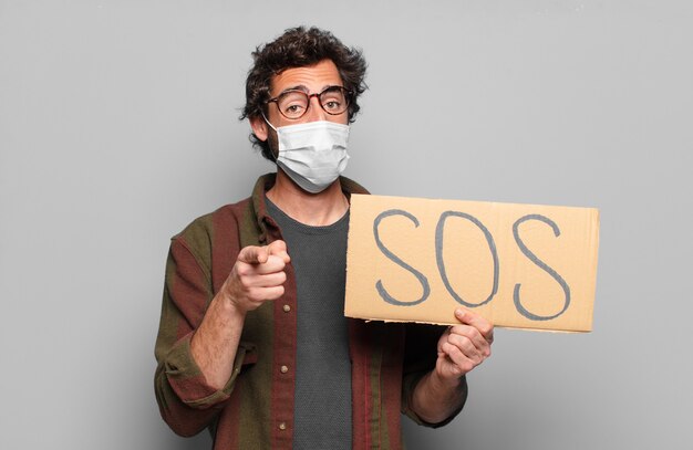 Young bearded man with a medical mask. sos concept