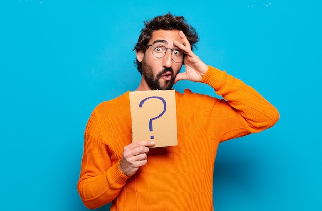 Young bearded man with a question mark symbol