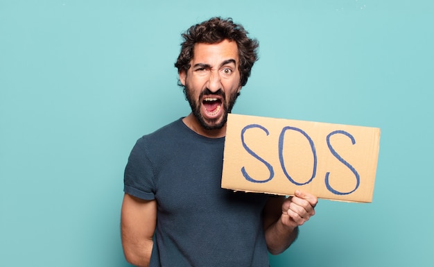 Young bearded man with SOS board