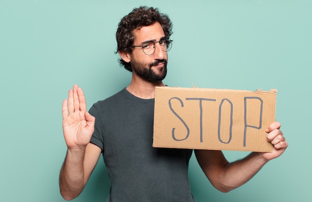 Young bearded man with stop sign