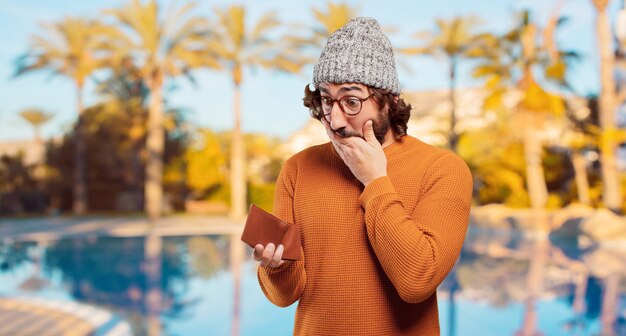 Young bearded man with a wallet