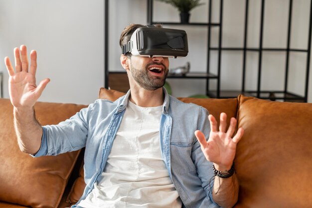 Young bearded millennial guy wearing VR headset