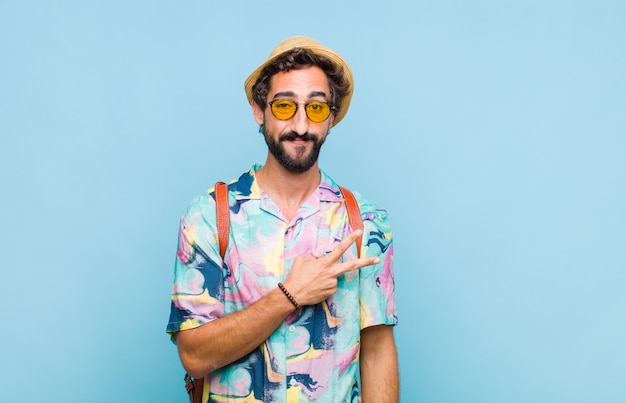 Young bearded tourist man feeling happy, positive and successful