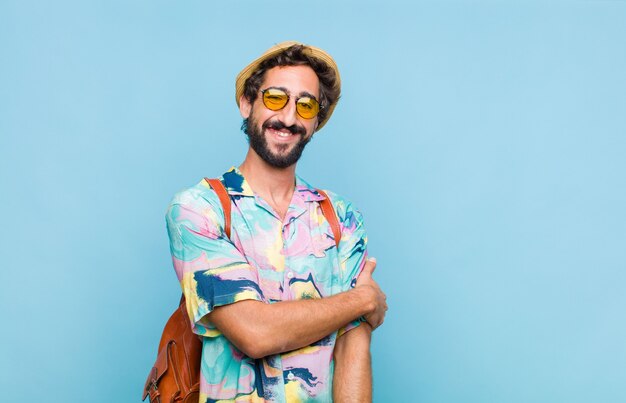 Young bearded tourist man laughing shyly and cheerfully