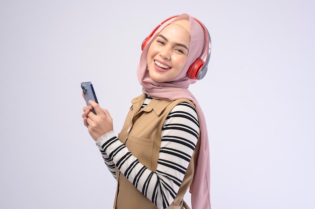 A young beautifu musliml woman wearing headset on white background