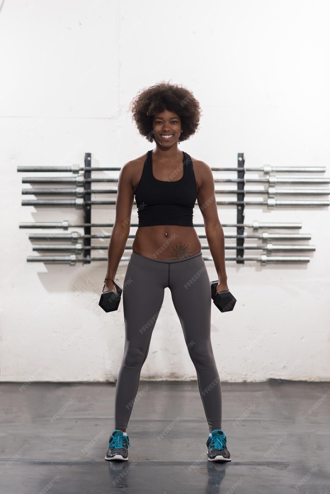 Premium Photo | Young beautiful african american woman doing bicep