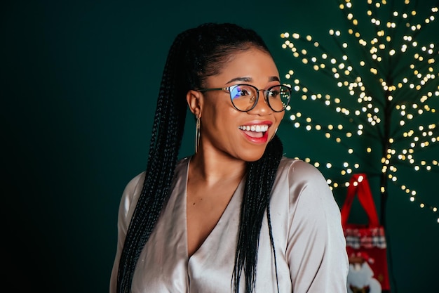 Young beautiful African American woman smiling and playing with Christmas decorations