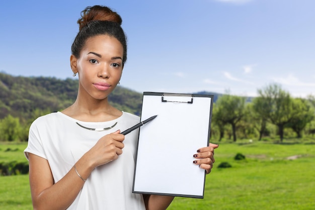 Young beautiful african american woman with clipboard