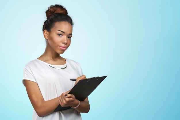 Young beautiful african american woman with clipboard