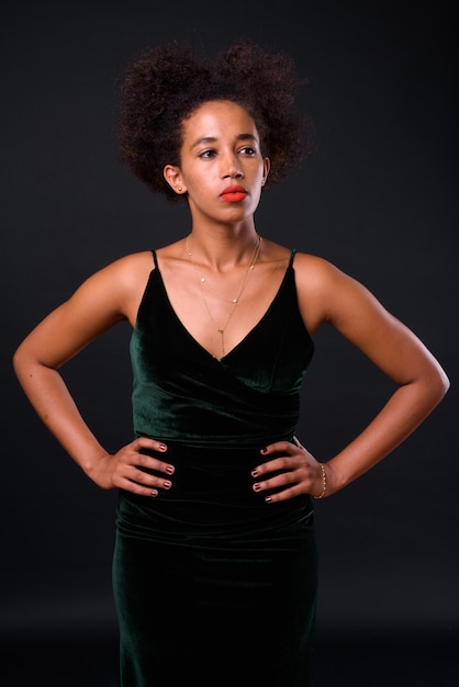 young beautiful African woman with Afro hair on black