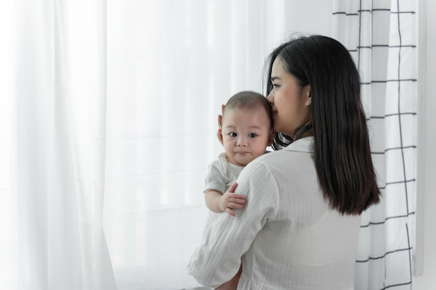 그녀의 작은 귀여운 신생아와 함께 젊은 아름 다운 aisan 어머니