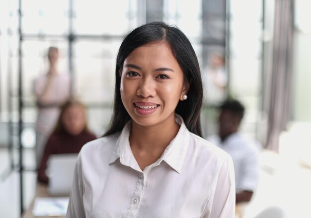 Young beautiful Asian business woman consultant portrait of an employee looking at the camera