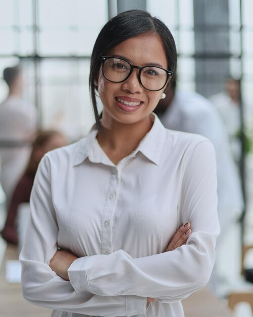 Young beautiful Asian business woman consultant portrait of an employee looking at the camera