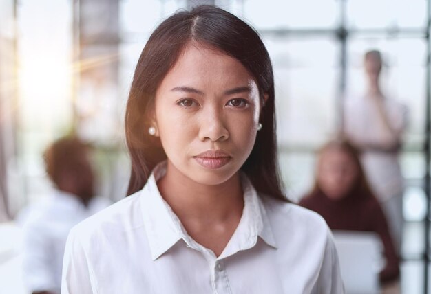 Young beautiful asian business woman consultant portrait of an employee looking at the camera