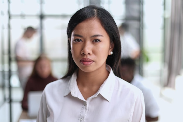 Young beautiful Asian business woman consultant portrait of an employee looking at the camera