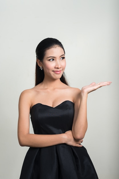 young beautiful Asian businesswoman against white space