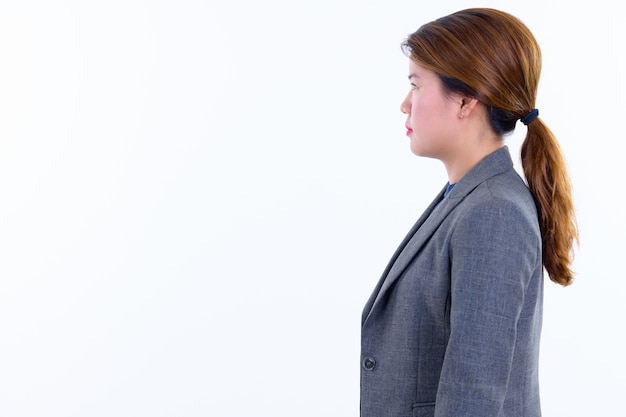  young beautiful Asian businesswoman isolated against white wall