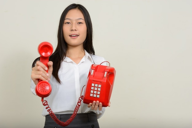 young beautiful Asian businesswoman on white