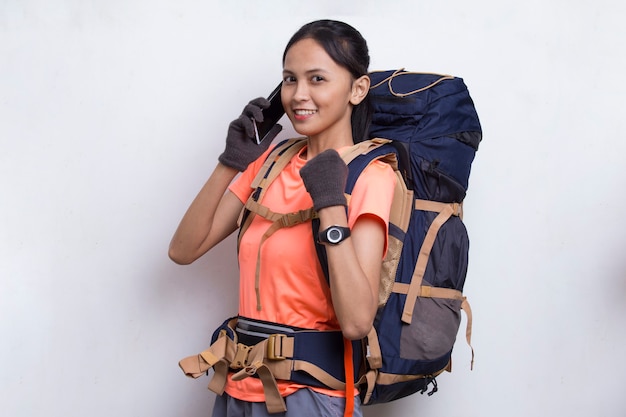 Young beautiful asian hiker woman using mobile phone isolated on white background