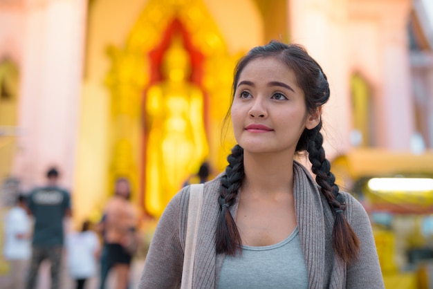 Young beautiful Asian tourist woman exploring Nakhon Pathom