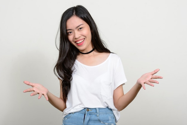 young beautiful Asian woman against white space