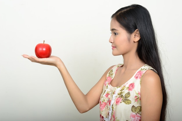  young beautiful Asian woman against white wall