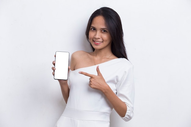 Young beautiful asian woman demonstrating mobile cell phone isolated on white background