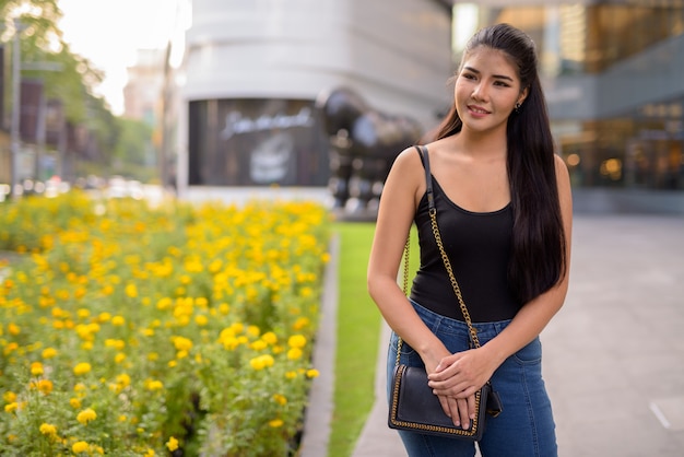 Young beautiful Asian woman exploring around the city