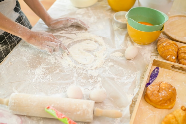 a young beautiful asian woman is baking in her kitchen  , bakery and coffee shop business