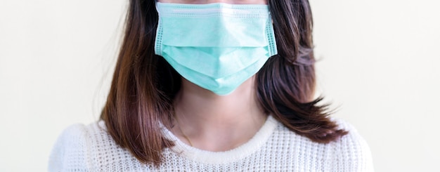 Young  beautiful asian woman showing how to wear a medical mask or  showing how to correctly wear hygiene surgical mask step by step on white background