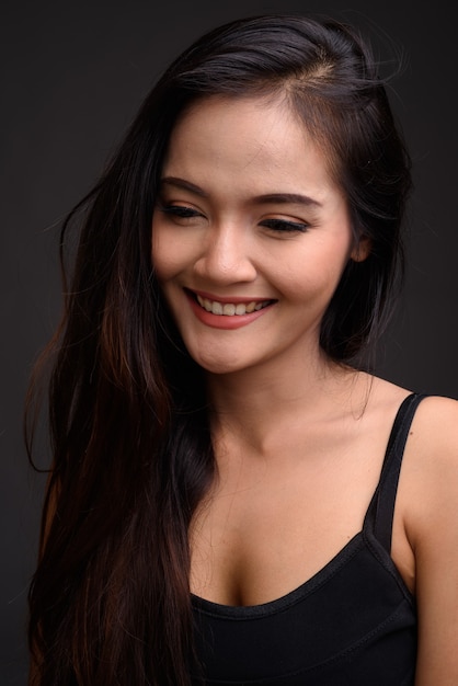 Young beautiful Asian woman smiling