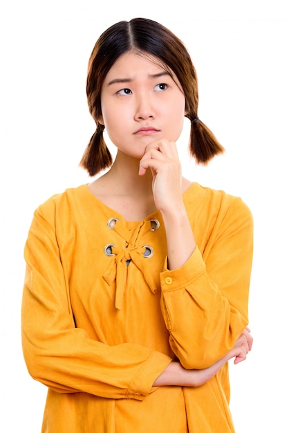 young beautiful Asian woman thinking while looking up