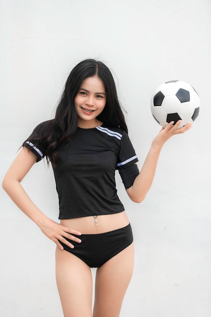 Young beautiful asian woman wear soccer player cheer sportFemale fans football cheering game