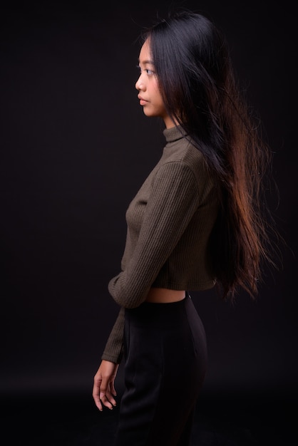 young beautiful Asian woman wearing turtleneck sweater