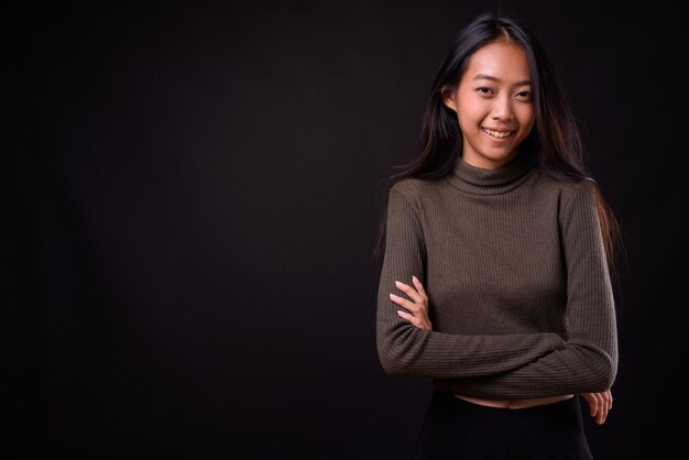 young beautiful Asian woman wearing turtleneck sweater