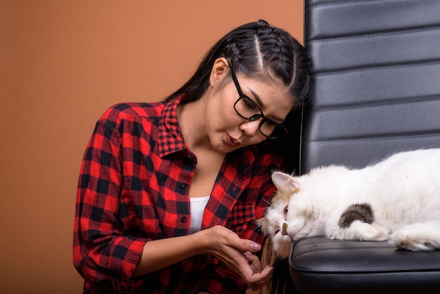 Young beautiful Asian woman with Persian cat